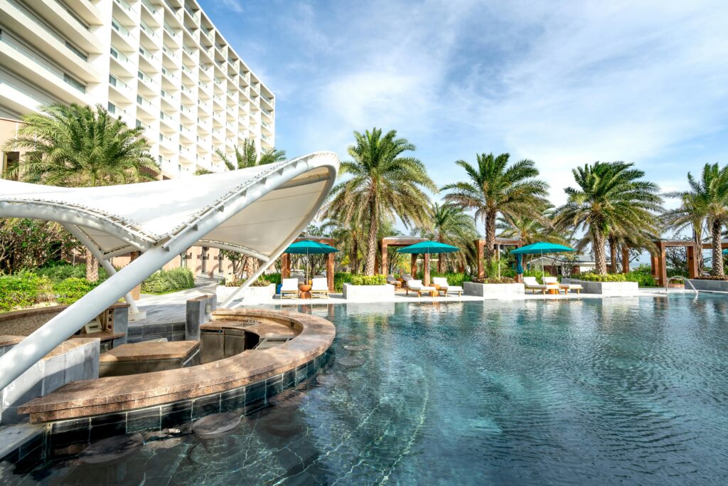 pexels-photo-12387909-12387909 Explore this serene resort poolside, surrounded by lush palm trees and luxury amenities.